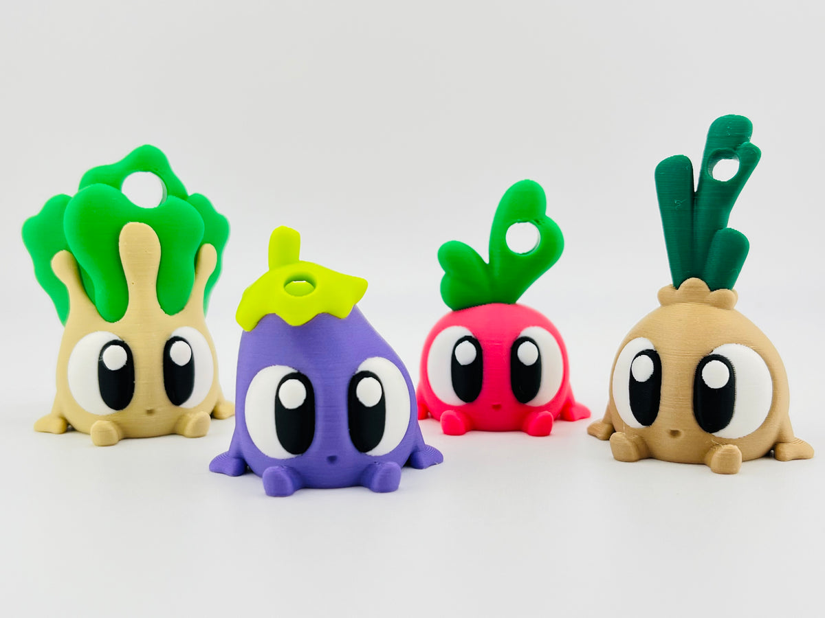 Row of vegetable fidget toys: pak choi, aubergine, radish and onion
