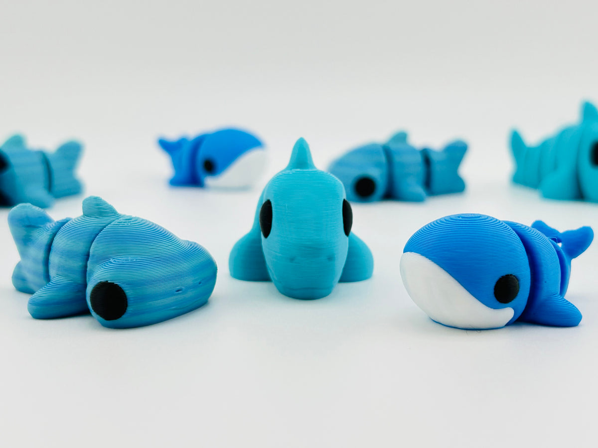 Blue 3D printed whale and whale shark fidget toys grouped together