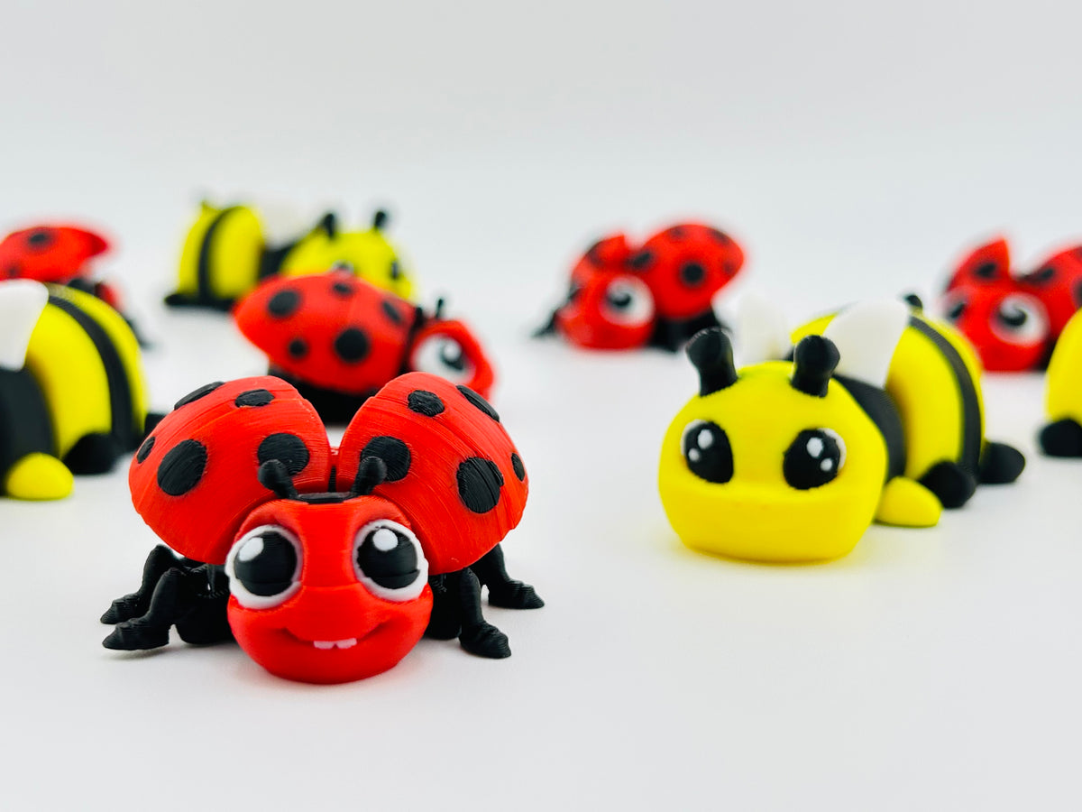 Red ladybird and yellow bumble bee fidget toys together