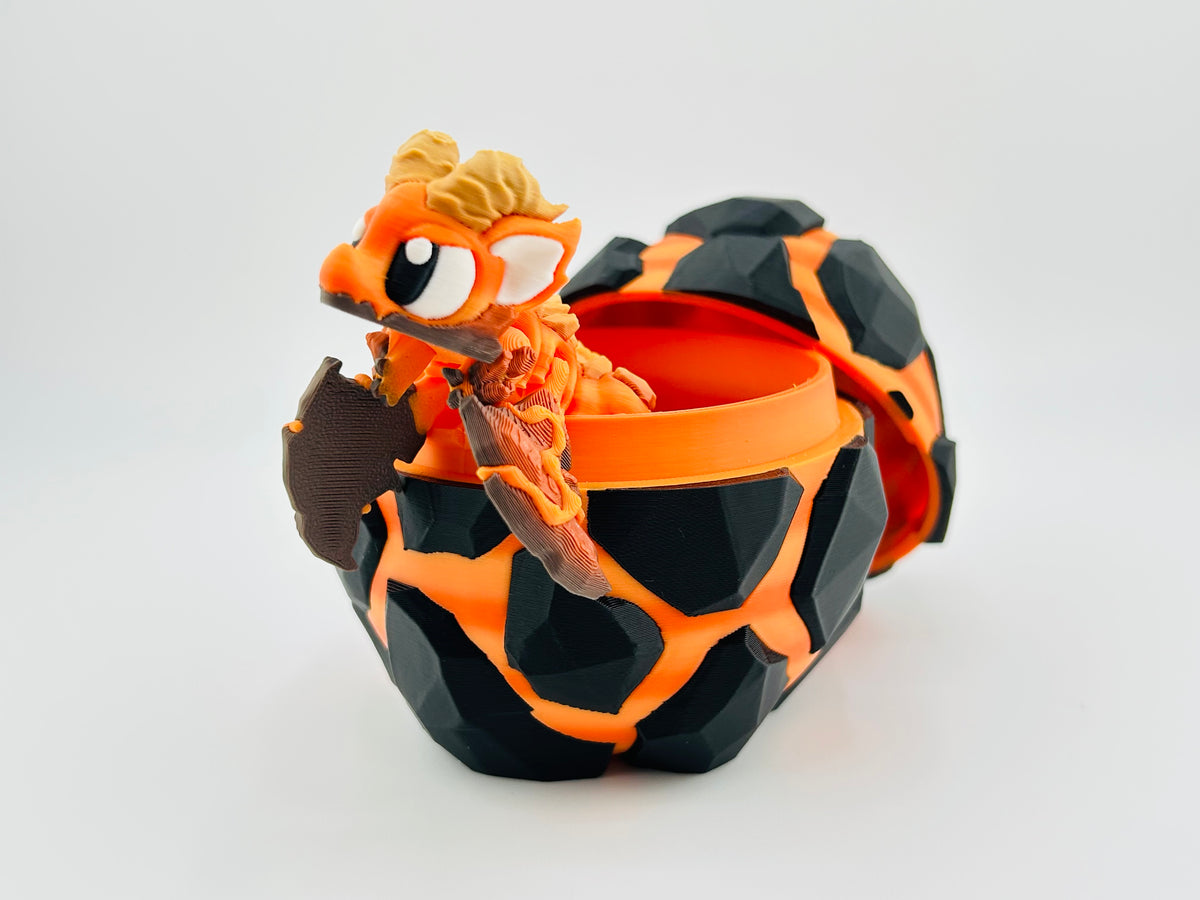 Black and orange lava-pattern dragon egg opening to reveal an orange baby dragon