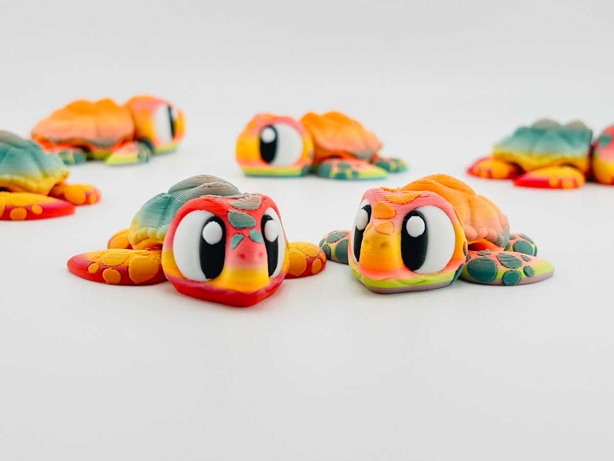 Rainbow tattooed turtle fidget toys with big eyes, grouped together