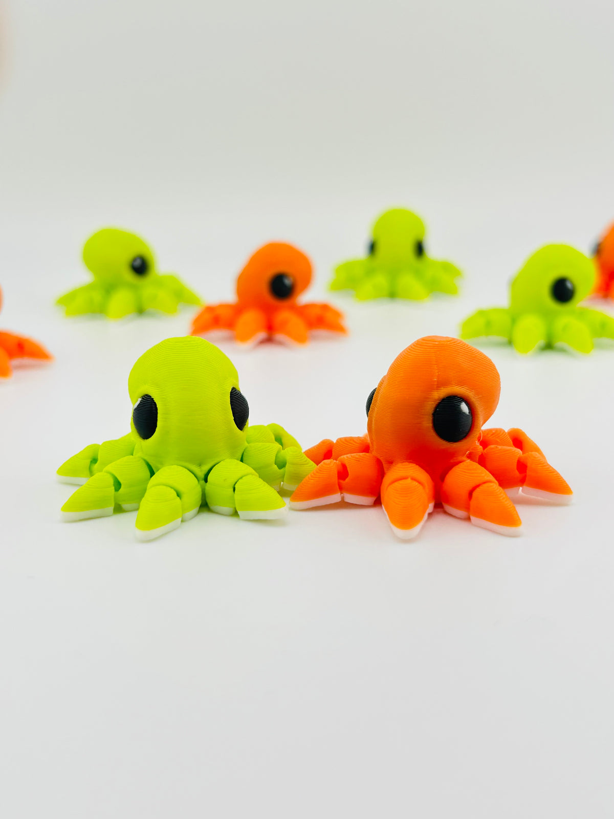 Lime green and orange baby octopus fidget toys